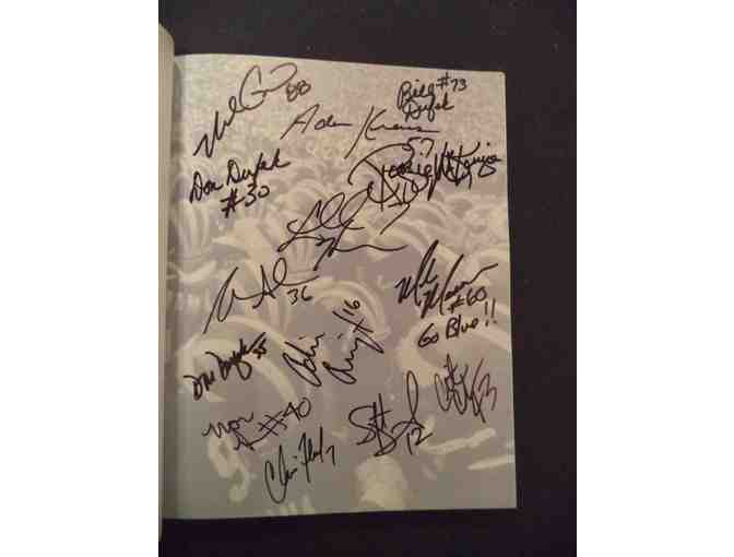 TRADITION book signed by Charles Woodson and 22 other Michigan greats.