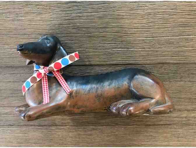 Laying down dachshund figurine with bow
