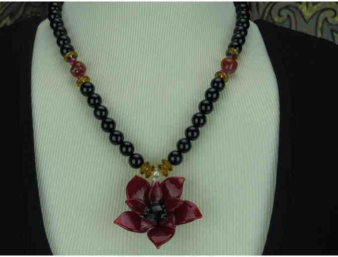 ! Romantic, Necklace features a Beautiful Art Glass Flower on a strand of Genuine Onyx!