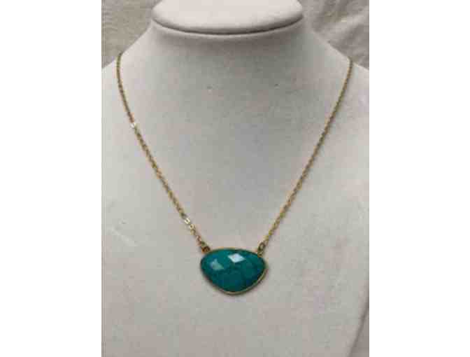 Turquoise colored pendant on  gold tone chain