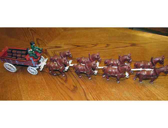 Eight-horse team with wagon and two riders. Cast iron.