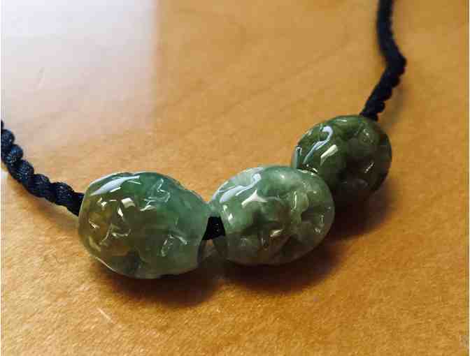Three Carved Jade Beads on Black Cord