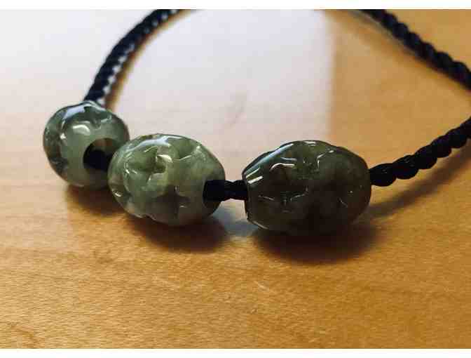 Three Carved Jade Beads on Black Cord