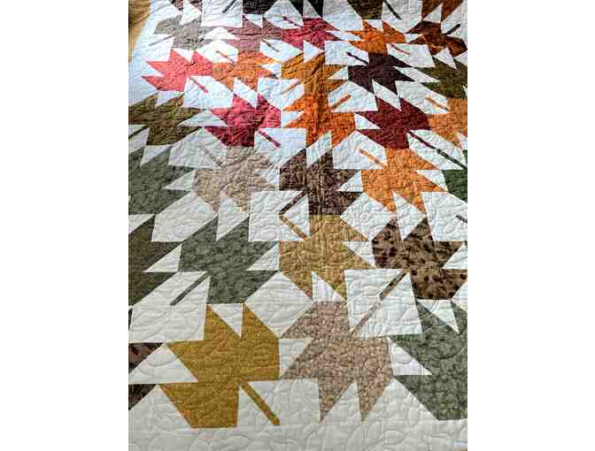 Beautiful fall themed quilt with large quilted maple leaves