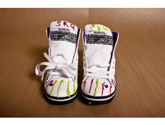 Tegan and Sara decorate a pair of their signature shoes in White