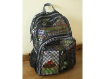 Black backpack filled with teaching supplies