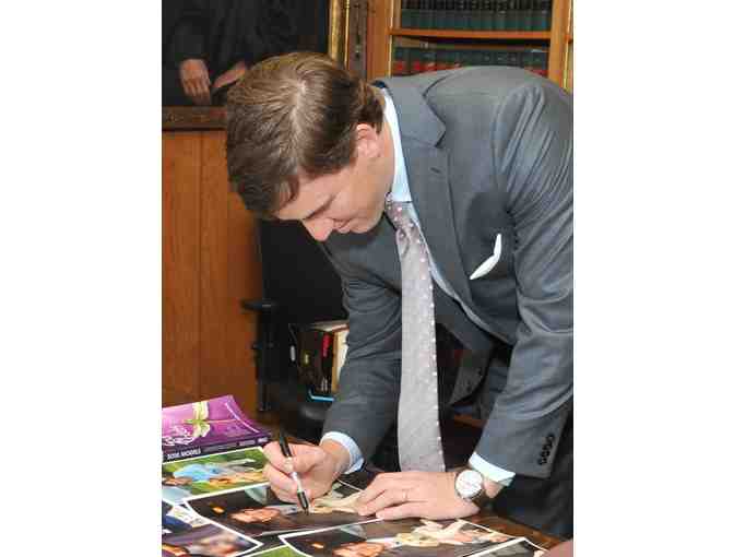 Autographed Photo of Eli Manning with Guiding Eyes Puppy