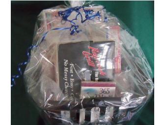 Coupon for an oil change at 'Lawless' accompanied by a sports theme gift basket