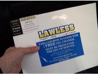 Coupon for an oil change at 'Lawless' accompanied by a sports theme gift basket