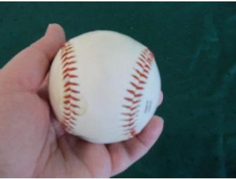 Coupon for an oil change at 'Lawless' accompanied by a sports theme gift basket