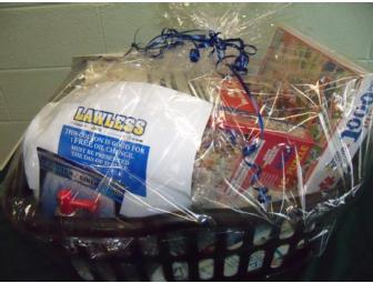 Coupon for an oil change at 'Lawless' accompanied by a sports theme gift basket