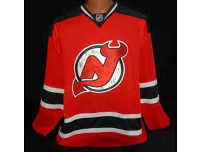 A 2014-15 Autographed New Jersey Devils Jersey Signed by the Team.