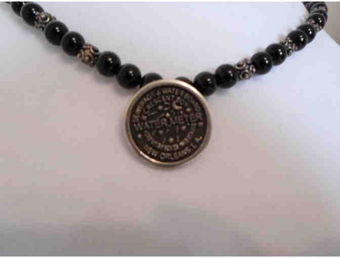 Onyx and silver necklace with a New Orleans Water Meter pendant