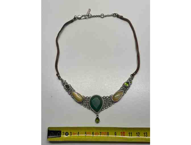 Necklace with various stones on metal linked base on a leather cord.(JP)