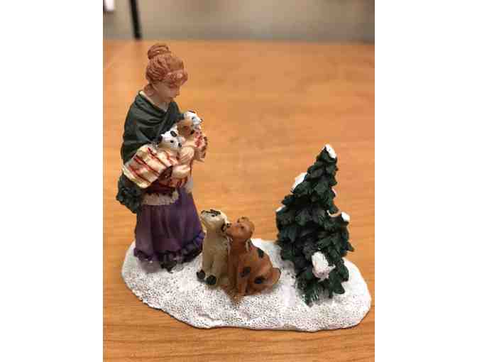 Christmas woman with dogs figurine