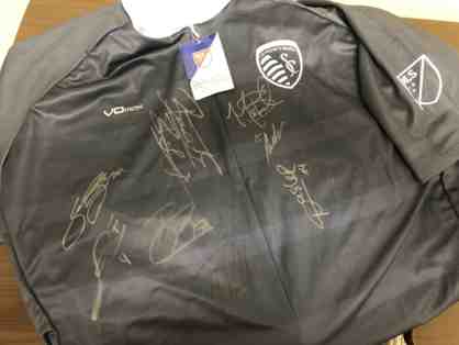 Sporting KC cycling jersey with multiple autographs.
