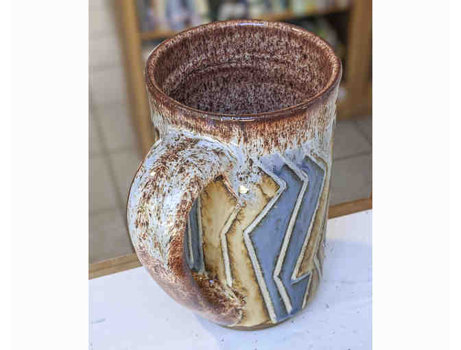 Footed tall mug with wood ash glaze, by Pond Farm student, Pedar Hegland.
