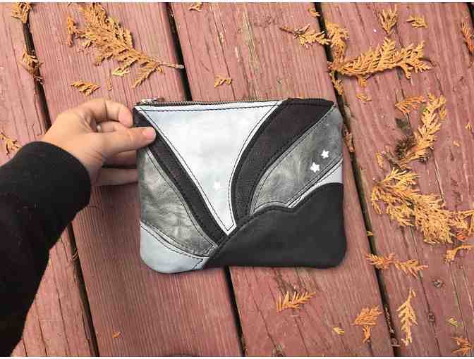 Handmade leather clutch bag by local artist
