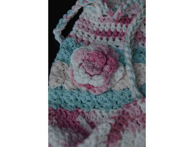 Pink and blue crocheted bag with flowers