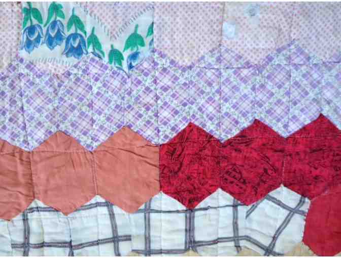 Beautiful vintage quilt with classic hexagon pattern